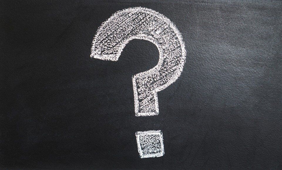 A chalk drawing of a question mark on a blackboard.